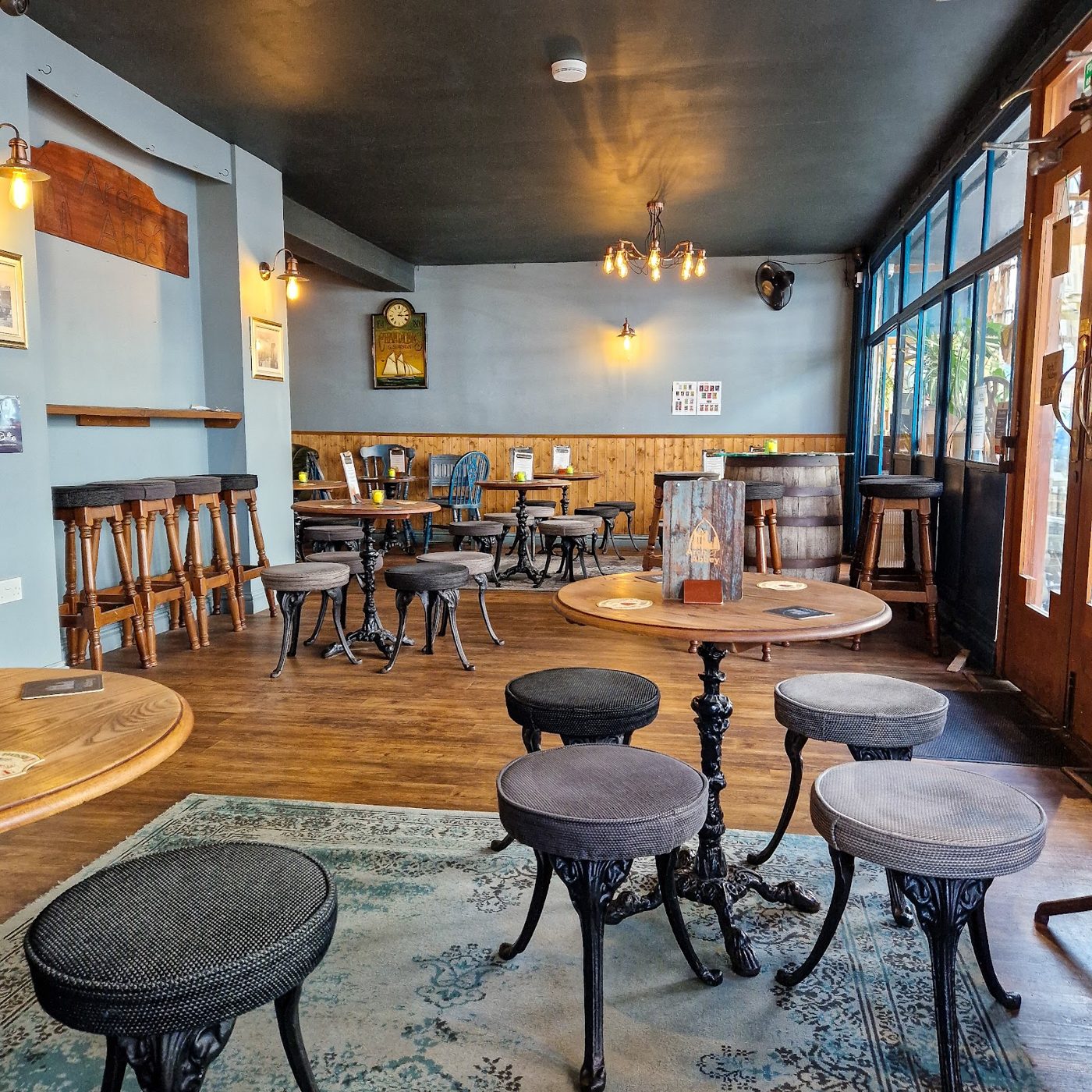 Inside Arch & Abbey: tables and stools